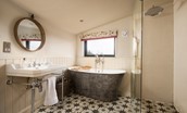 The Treehouse - en suite bathroom with a large, freestanding bath and walk-in shower