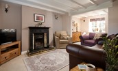Rose Cottage, Huggate - the evening sitting room with decorative fireplace and beamed ceiling
