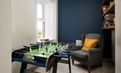 Castle View, Bamburgh - snug area with table football and a selection of board games and books