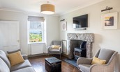 Culdoach Cottage - open plan living space with log burner, TV, and comfortable seating