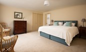 Wark Farmhouse - bedroom two with zip and link beds, inbuilt wardrobes and chest of drawers