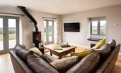 The Granary at Rothley East Shield - living room with wood burner and views of surrounding countryside
