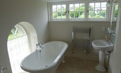 Abbey House - bedroom two en suite bathroom with roll top bath, basin, WC and walk-in shower