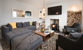 Albero - sitting room with corner sofa, wood burning stove and TV