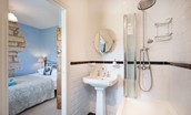 April Cottage - bedroom one with monochrome en suite bathroom