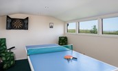 April Cottage - the external games room with table tennis table, dart board and coastal views