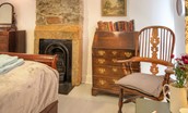 Artist's Cottage - bedroom one with decorative fireplace, writing bureau and dressing table