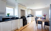 Sea Breeze - well-equipped kitchen with wooden dining table seating 6 guests