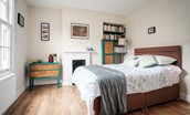Number 107 - bedroom one with a king size bed, wardrobe and chest of drawers
