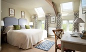 Brunton Granary - bedroom two with super king size bed, dressing table and Velux windows offering super views of the surrounding countryside