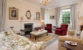 Edenside House - drawing room with plenty of seating, decorative fireplace and dual aspect views over the garden