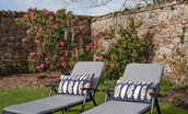 Hiddenhus - sit back and relax on the comfortable sun loungers surrounded by colourful shrubbery
