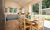 The Coach House, Kingston - kitchen with dining area and doors leading into garden