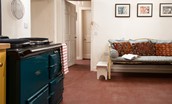 Church House - traditional features include a dual oven teal-coloured AGA and ceiling-mounted pulley above
