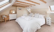 Beachcomber Cottage - bedroom one with super king bed and ceiling beams