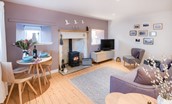 Braemar - sitting room with wood burning stove and dining space for two guests
