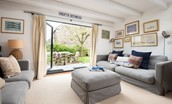 Nook - bright and spacious sitting room with comfortable seating and large bi-fold doors opening out onto the garden