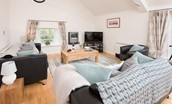 Budle Bay Loft - open-plan living area with large sofas, armchair and Smart TV
