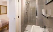Budle Bay Loft - bedroom one en suite bathroom with walk-in shower, WC and basin