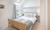 Budle Bay Loft - bedroom two with double bed and blue tones
