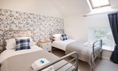 Budle Bay Loft - bedroom three with twin beds and navy tones