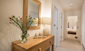 Budle Bay Loft - hallway with console table and access to bedrooms
