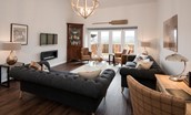 Byre - sitting room with bi-folding doors to garden and views over Eildon hills and countryside
