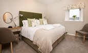 Byre - bedroom one with zip and link beds in neutral tones
