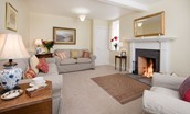 Byreman's Cottage - sitting room with two sofas, armchair and open fire