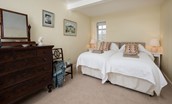 Byreman's Cottage - bedroom one with zip and link beds, bedside tables and large dresser