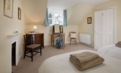 Byreman's Cottage - bedroom three with dressing table, chest of drawers and decorative fireplace