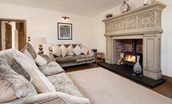 Captain's Rest - two large sofas are set around the large statement fireplace and wood burning stove