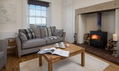 Chaffinch Cottage - sitting room with sofa, coffee table and wood burning stove