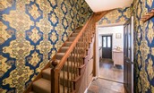 Chestnut Cottage - hallway with statement wallpaper and staircase leading to the first floor