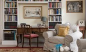 Coachman's Cottage - sitting room with armchair, desk and extensive library
