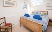 Coldstream Coach House - bedroom one with double bed and side tables