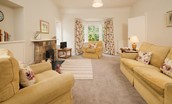 Daffodil Cottage - sitting room large sofa, armchairs and wood burning stove
