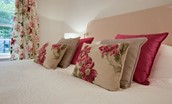 Daffodil Cottage - bedroom one with floral cushions and curtains