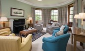 Edenside House -sitting room on the first floor with six armchairs, TV and original panelling