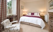 Edenside House - bedroom two on the first floor with zip and link beds, dressing table, side tables and chest of drawers