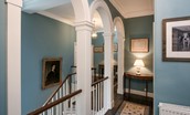 Edenside House - grand landing on the first floor with arches and blue colour scheme