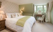 Edenside House - bedroom four on the second floor with zip and link beds, side tables, dressing table and panelling