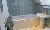 Ellemford Estate - bedroom four en suite bathroom with bath and shower over, WC and basin