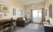 The Fairway - adjoining snug with large sofa, desk, and sea views