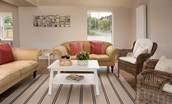 Coldwells Farmhouse - the sitting room area with two sofas and two armchairs