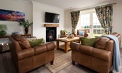 Greenhead Cottage - relax in front of the electric stove on the soft leather sofa and armchairs