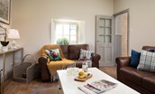 Lookout Cottage - spacious sitting room with two sofas, smart TV and multi fuel stove