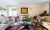 The Old Millhouse - the drawing room has ample seating around the open fire