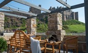 Caste View, Bamburgh - spacious patio with outdoor fireplace and views of Bamburgh Castle