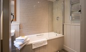 Park End - bath with shower and heated towel rail in the bathroom